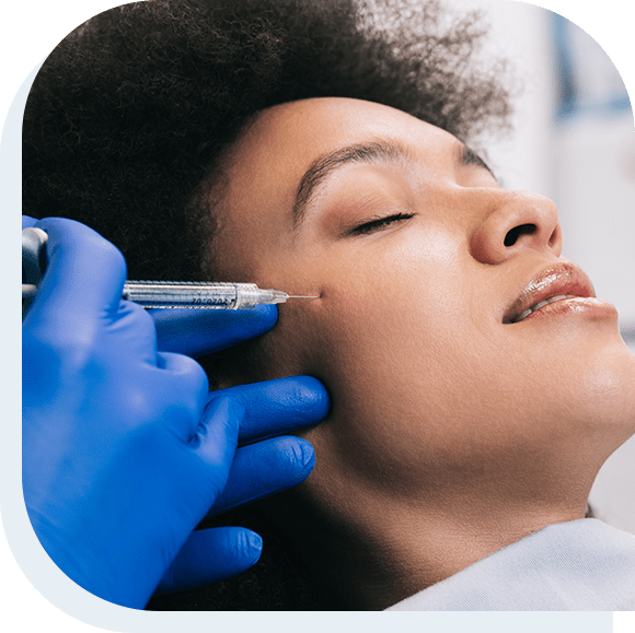 Attractive young African woman is getting a rejuvenating facial injections