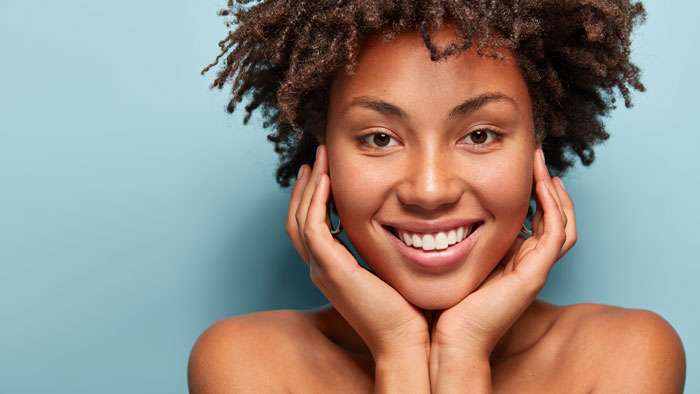 Close up portrait of relaxed black woman has gentle skin