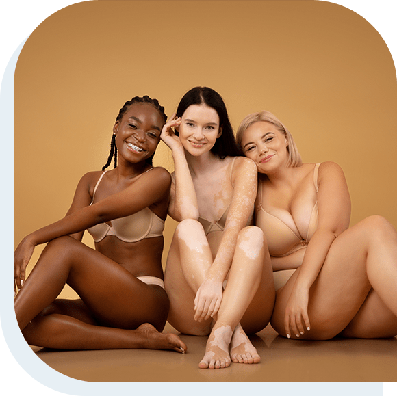 Three attractive multicultural women in lingerie with different skin and body type sitting on floor