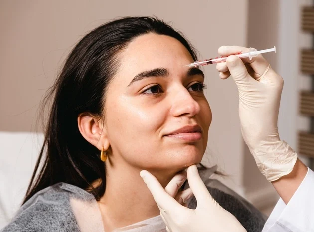 A doctor gives botox injections to prevent wrinkles on the face