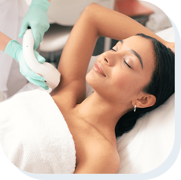 A young woman having laser hair removal procedure on her armpit