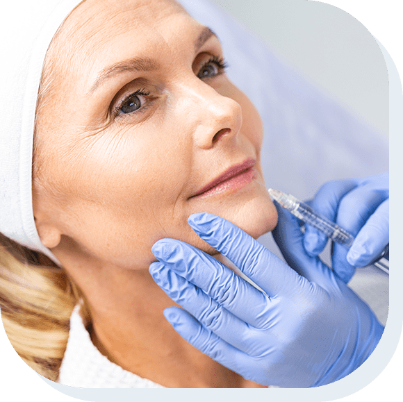 Close up portrait of a dreamy mature woman receiving a beauty injection in her bottom lip