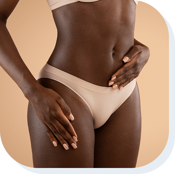 Cropped of dark skinned woman in nude underwear holding hand on belly