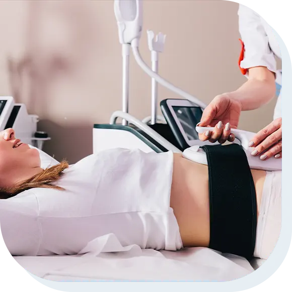 Woman getting treatment on abdomen to burn fat and build muscles, slimming technology